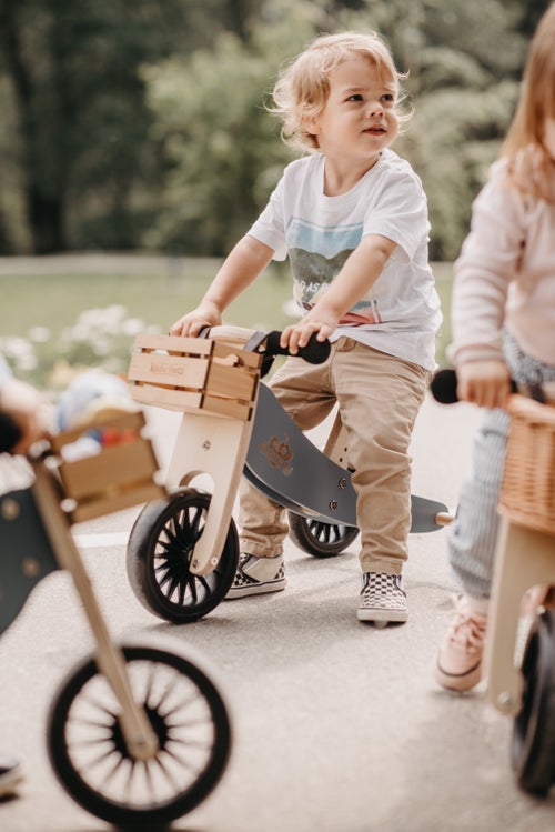 Kinderfeets Tiny Tot Plus tricycle balance bike wooden training bike running bike no pedals toddler children kids birch wood slate blue and wooden crate basket