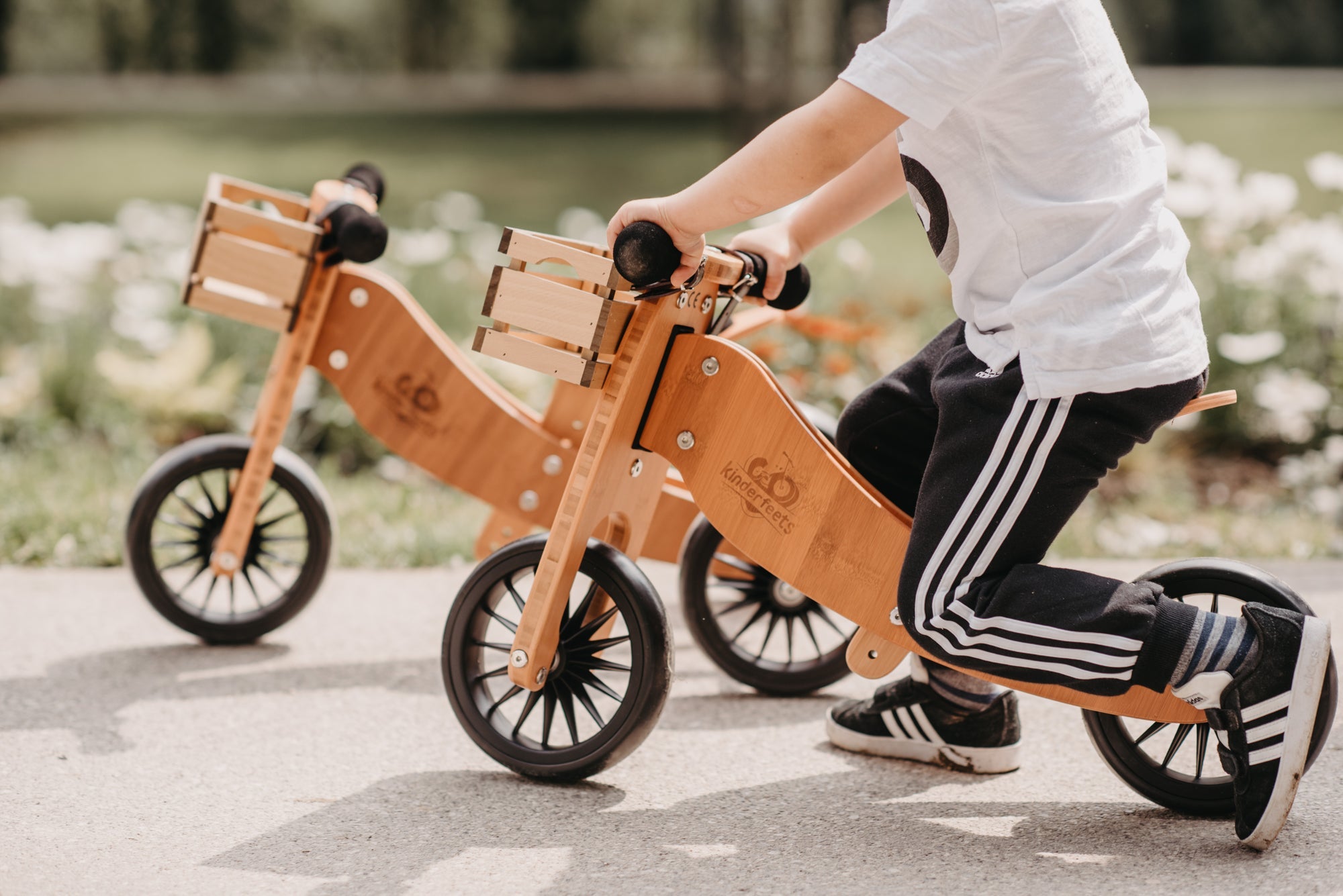 Kinderfeets Tiny Tot Plus tricycle balance bike wooden training bike running bike no pedals toddler children kids birch wood white and wooden crate basket
